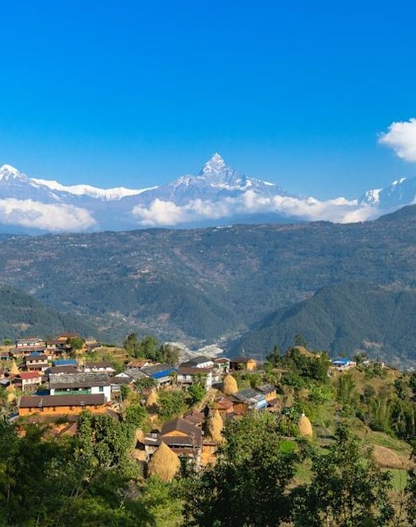 Hill village with snow-capped Himalaya in Nepal